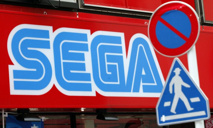 A Sega Corp signboard is seen behind traffic signs at the Akihabara electronic store district in Tokyo