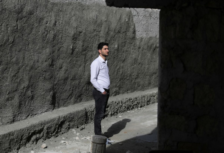 Abdel Hamid al-Youssef, an internally displaced man who says his wife and infant twins were killed when poison gas was dropped on their home town of Khan Sheikhoun in 2017, stands outside his house in the rebel-held town of Sarmada in Idlib province, Syri