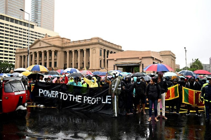 Thousands of Sri Lankans braved heavy rains to keep up a demonstration outside the leader's seafront office in the capital Colombo for a second day