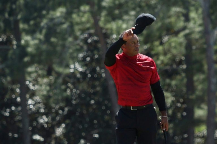 Thankful: Tiger Woods tips his hat to the crowd on the 18th green in the final round of the 86th Masters at Augusta National
