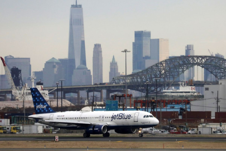 A JetBlue passenger jet lands with New York City as a backdrop, at Newark Liberty International Airport, New Jersey, U.S. December 6, 2019. 