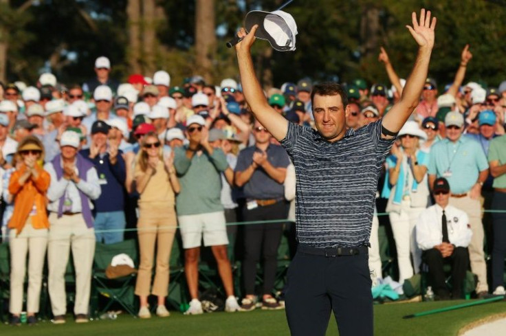 World number one Scottie Scheffler celebrates on the 18th green after winning the 86th Masters at Augusta National Golf Club