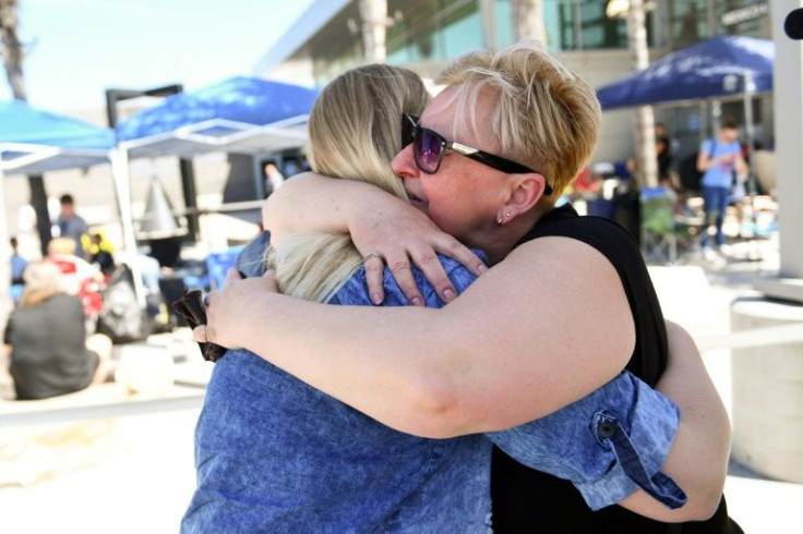 Nadiya Ruyhynska (R) hugs her daughter Christina after crossing into the US from Tijuana, Mexico at the end of a long journey from Ukraine; she was one of thousands of Ukrainians entering the US from Tijuana