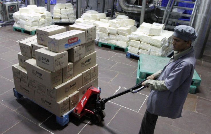 A worker moves a trolley loaded with packed processed cheese during a media tour to Amul satellite dairy in Khatraj village, located in the western Indian state of Gujarat June 29, 2011.