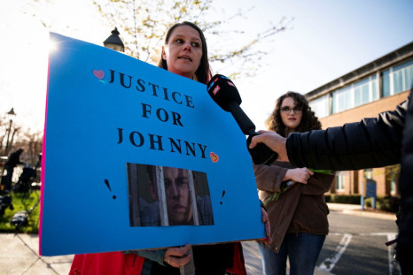 Tiffany Lunn, from St. Marys County, Maryland, speaks to members of the media as she holds a poster outside of the Fairfax County Circuit Courthouse, before jury selection in the Johnny Depp defamation case against Amber Heard, in Fairfax, Virginia, U.S.,