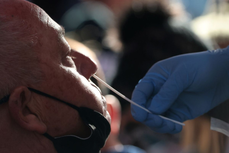 A person takes a COVID-19 test in Times Square as the Omicron coronavirus variant continues to spread in Manhattan, New York City, U.S., December 26, 2021. 