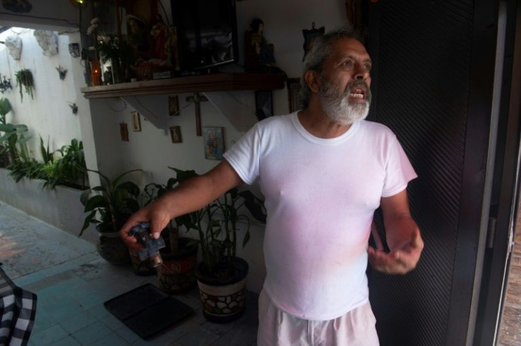 Alejandro Raya, 57, shows a gas cylinder valve that he found in a street in the Huichapan neighborhood near the former refinery