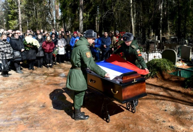 Soldiers cover Avrov's coffin with the national flag -- exact Russian fatalities are not known, with the latest official tally of 1,351 given on March 25