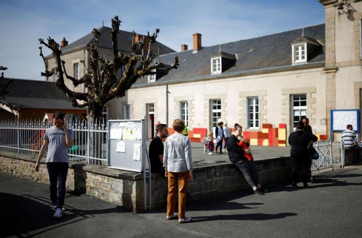 Parents wait for their children leaving school in Gouzon, the day after the first round of the 2022 French presidential election, France, April 11, 2022.