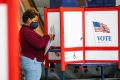 A woman fills her ballot in a privacy booth while voting in the gubernatorial election in Newark, New Jersey, U.S., November 2, 2021. 