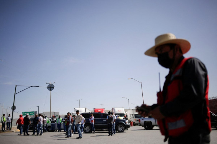 Truckers returning from the United States wait near their trailers while stranded at a protest, by Mexican truck drivers blocking the Zaragoza-Ysleta International Bridge connecting the city of Ciudad Juarez to El Paso, Texas, against truck inspections im