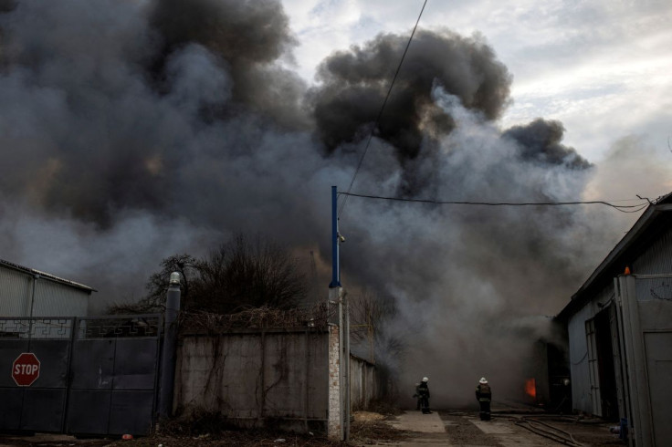 Firefighters try to contain a fire at a plant following Russian shelling, as Russia's attack on Ukraine continues, in Kharkiv, Ukraine, April 11, 2022. 