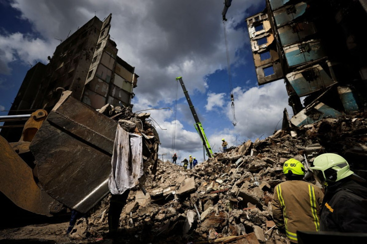 Rescuers search for bodies under the rubble of a building destroyed by Russian shelling, amid Russia's Invasion of Ukraine, in Borodyanka, Kyiv region, Ukraine April 11, 2022. 