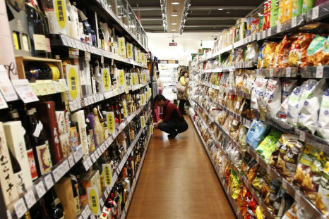 A shopper looks at alcohol products at an aisle in a luxury food store in Tokyo September 25, 2014. 