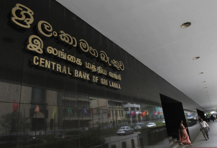 People walk at the Central Bank of Sri Lanka building in Colombo February 12, 2013. 