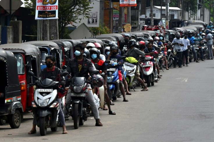 Motorcyclists queue to fill their tanks in Colombo
