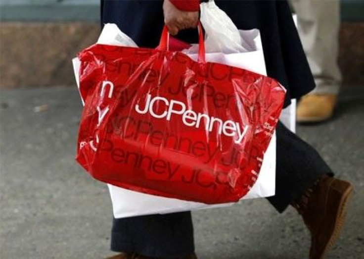 A pedestrian walks with a shopping bag from a JC Penney department store in New York