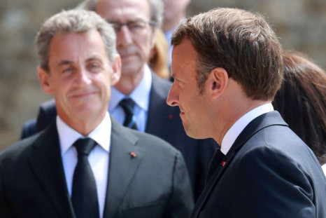 Former French President Nicolas Sarkozy and French President Emmanuel Macron arrive at a traditional annual ceremony at the Mont-Valerien, a memorial for the French who fought against the Nazis and those who were killed by the occupying forces, in Suresne