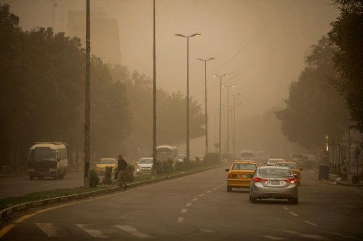 Vehicles drive through Baghdad under reduced visibility during a dust storm that engulfed much of central Iraq, the second such storm in a week