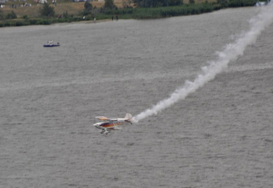 A small acrobatic plane flown by Marek Szufla crashes in the Vistula River during an air show in the city of Plock