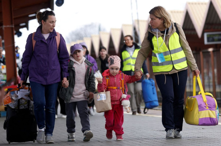 Ukrainian refugees walk on the platform after arriving on a train from Odesa at Przemysl Glowny train station, after fleeing the Russian invasion of Ukraine, in Przemysl, Poland, April 10, 2022.    