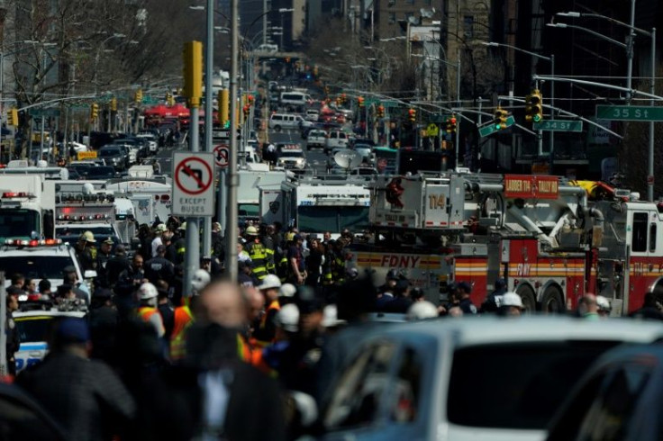 Members of the New York Police Department and emergency personel crowd the streets near a subway station in New York City on April 12, 2022