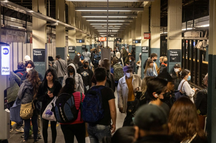 Commuters stand on a platform in Times Square station, after a shooting at a subway station in Brooklyn borough, in Manhattan, New York City, New York, U.S., April 12, 2022. 