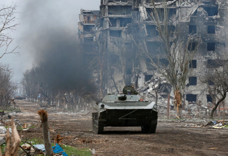 Service members of pro-Russian troops ride an armoured vehicle during fighting in Ukraine-Russia conflict near a plant of Azovstal Iron and Steel Works company in the southern port city of Mariupol, Ukraine April 12, 2022.