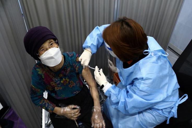 A South Korean elderly woman receives her first dose of the Pfizer-BioNTech coronavirus disease (COVID-19) vaccine at a vaccination centre in Seoul, South Korea April 1, 2021. Chung Sung-Jun/Pool via REUTERS