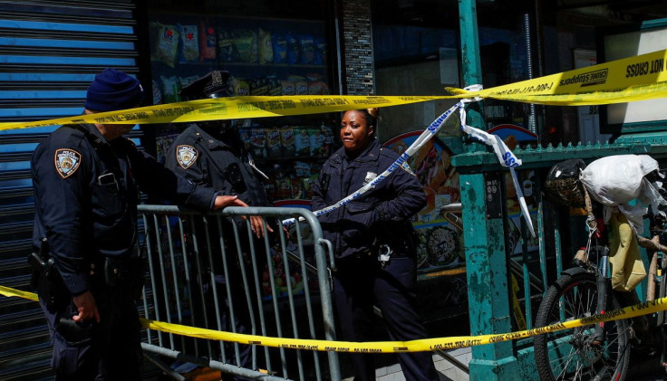 Law enforcement officers stand guard at the scene of a shooting at a subway station in the Brooklyn borough of New York City, New York, U.S., April 12, 2022. 