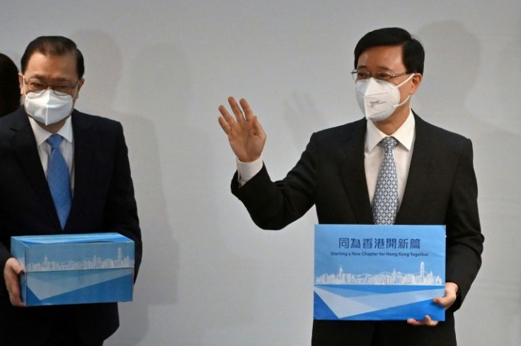 Hong Kong's former security chief John Lee waves before submitting his candidacy and nominations for the chief executive position