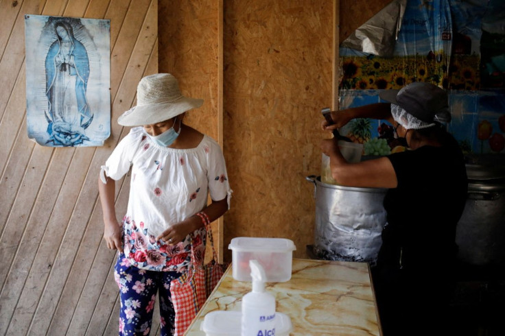 A woman is attended to in a soup kitchen in Pamplona Alta, a low-income neighbourhood on the outskirts of the Peruvian capital where soaring food prices are placing animal proteins out of reach for the most vulnerable residents, in Lima, Peru April 11, 20