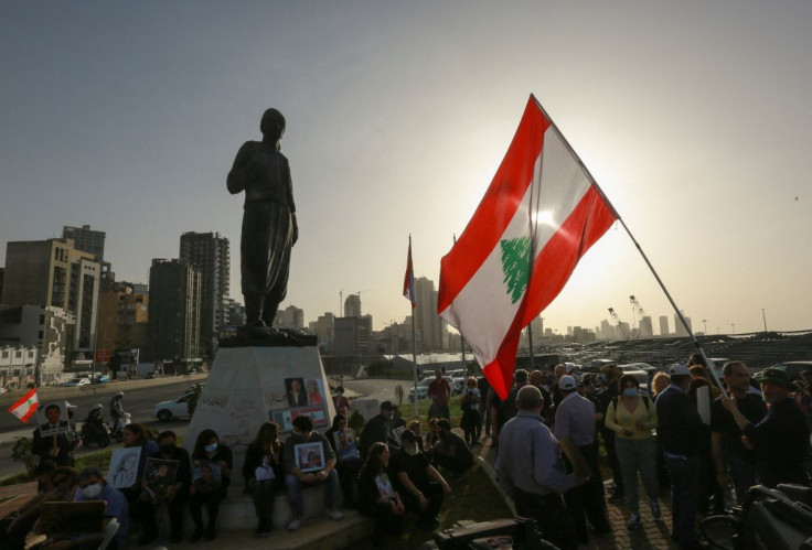 Families of the victims of the 2020 Beirut port explosion hold pictures during a protest near Beirut port, Lebanon April 4, 2022. Picture taken April 4, 2022. 