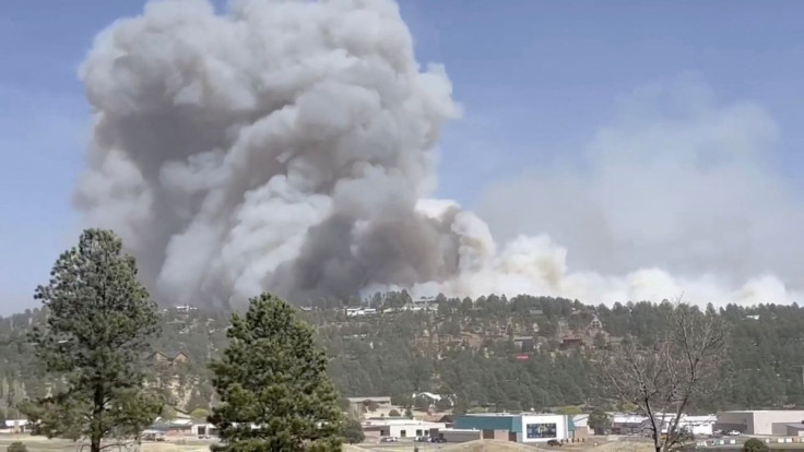 Smoke rises as a wind-driven wildfire, known as the McBride Fire, is seen burning on a ridge in Ruidoso, New Mexico, U.S. in this still image taken from a video obtained from social media April 12, 2022. Courtesy Melissa Gibbs/via REUTERS