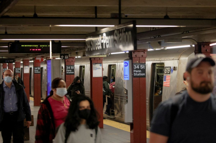 People walk at a subway platform a day after a Brooklyn subway station shooting incident, in Manhattan, New York City, New York, U.S., April 13, 2022. 