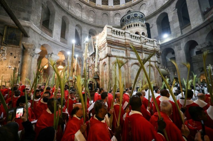 Roman Catholic clergy carry palm branches during the Palm Sunday procession at the Church of the Holy Sepulchre in Jerusalem's Old City