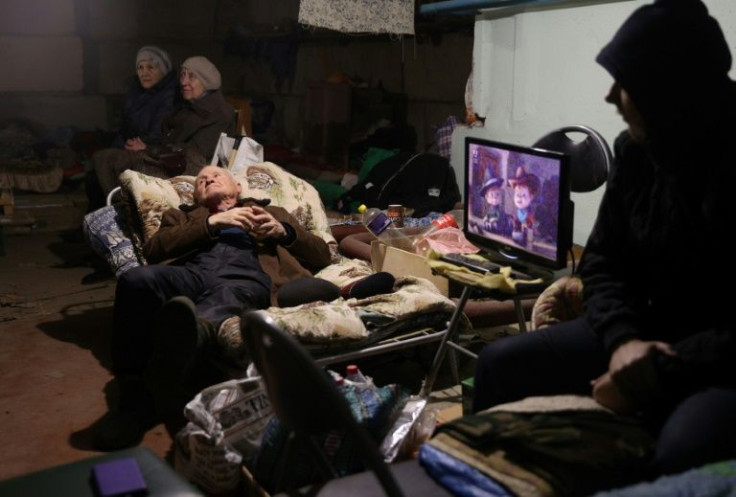 Local residents stay in the basement of a residential building to protect themselves from shelling in Lysychansk in the Luhansk region on April 13, 2022
