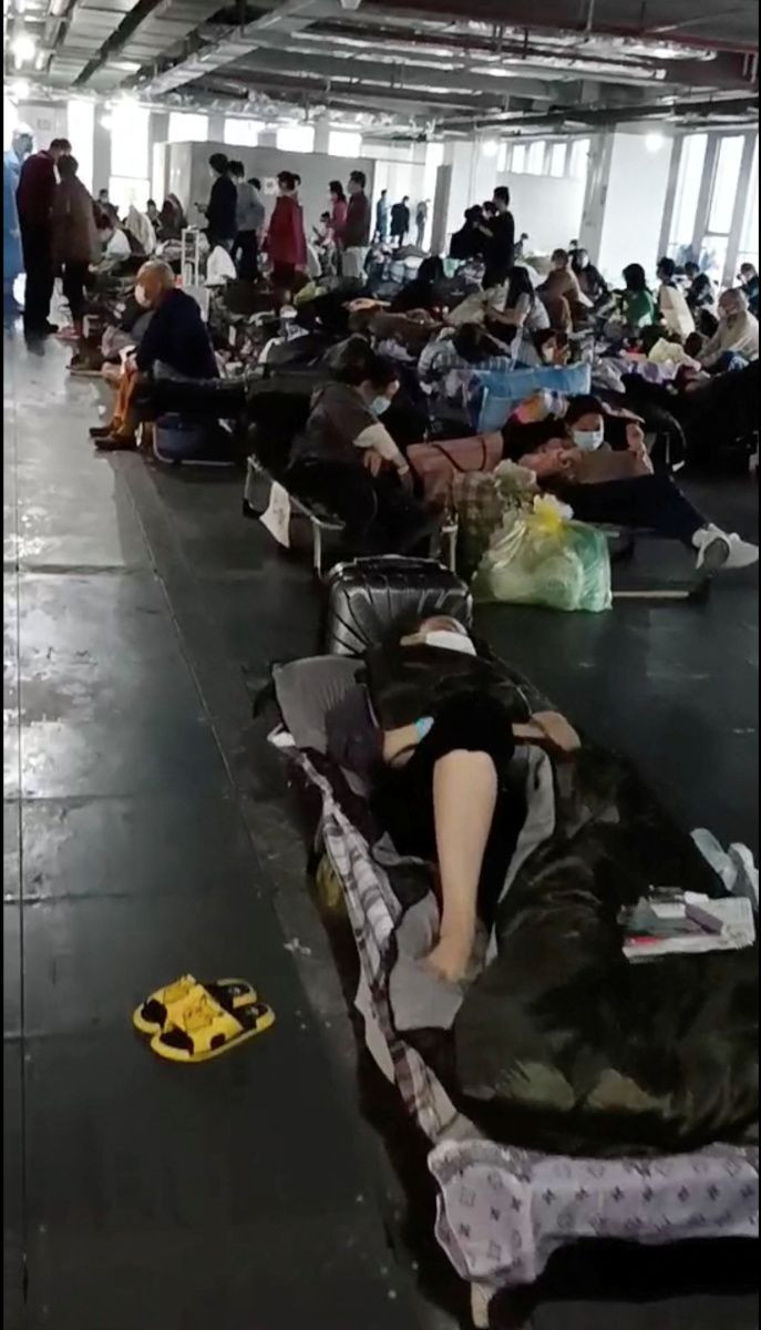 People rest at a quarantine centre near Linkong Skate Park in Changning District, Shanghai, China in this still image from a social media video obtained by Reuters on April 14, 2022.
