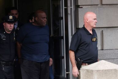 Frank James, the suspect in the Brooklyn subway shooting, is escorted from an NYPD precinct in Manhattan, New York City, U.S., April 13, 2022. 