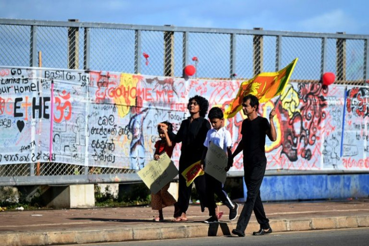 A family carrying placards walk along a road -- an unusual sight for this time of year