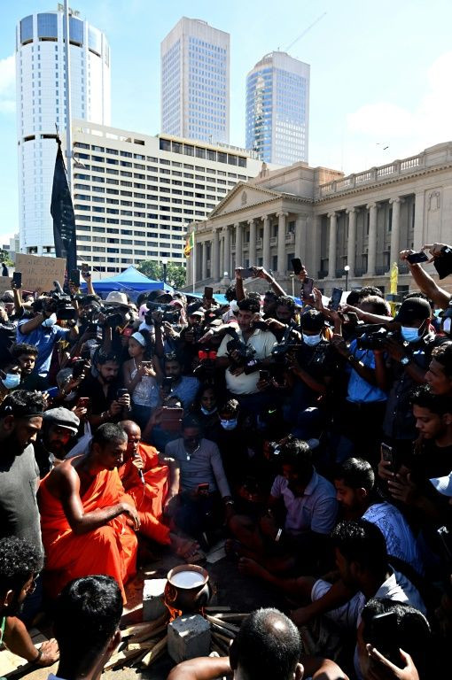 Buddhist monks boiled a pot of milk as protestors gathered outside the president's office
