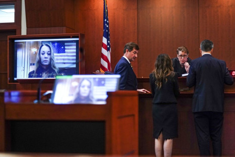 Judge Penney Azcarate talks with lawyers as a witness appears on a video screen during Johnny Depp's defamation case against ex-wife Amber Heard at the Fairfax County Circuit Court in Fairfax, Virginia, U.S., April 14, 2022. Shawn Thew/Pool via REUTERS