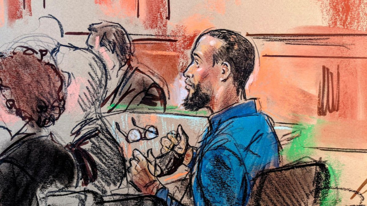 El Shafee Elsheikh, a former British national accused of engaging in lethal hostage-taking and conspiracy to commit murder as an alleged member of an Islamic State cell nicknamed "the Beatles" that operated in Syria and Iraq, takes off his face mask and