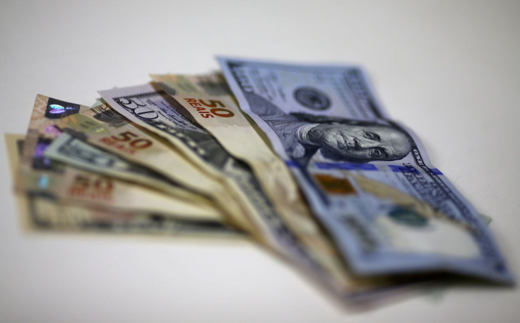 Brazilian Real and U.S. dollar notes are pictured at a currency exchange office in Rio de Janeiro, Brazil, in this September 10, 2015 photo illustration. 