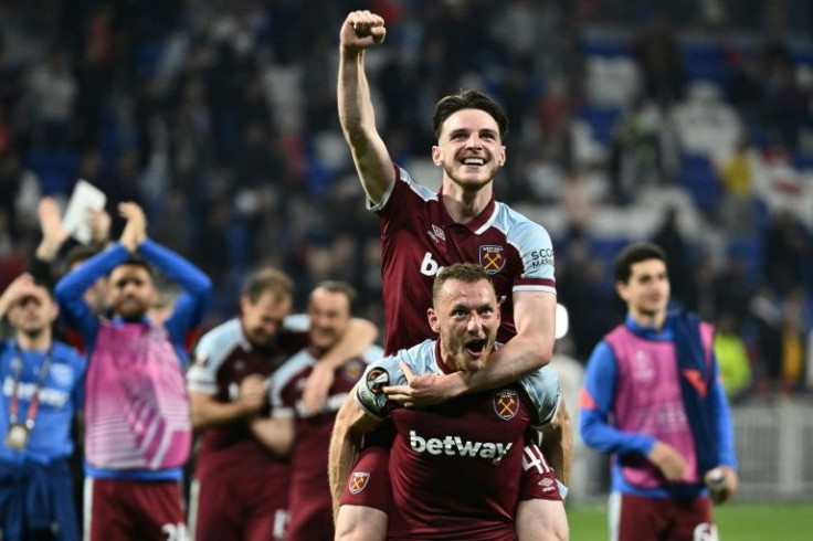 West Ham captain Declan Rice gets a ride on the back of Vladimir Coufal as they celebrate beating Lyon