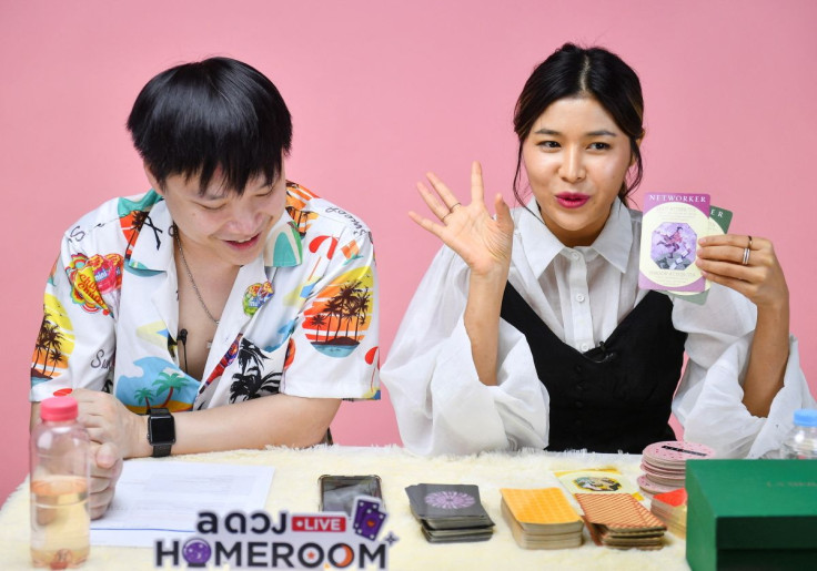 Fortune-tellers livestream a card reading session on an online platform, as many young Thais increasingly seek divination for quick answers, at their office in Bangkok, Thailand March 30, 2022.  