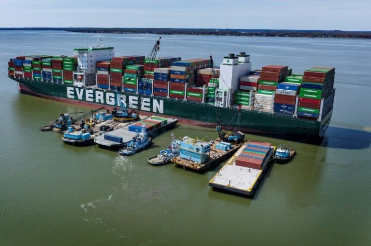 A tugboat pushes a barge full of containers away from the Ever Forward container ship in the Chesapeake Bay on April 11, 2022