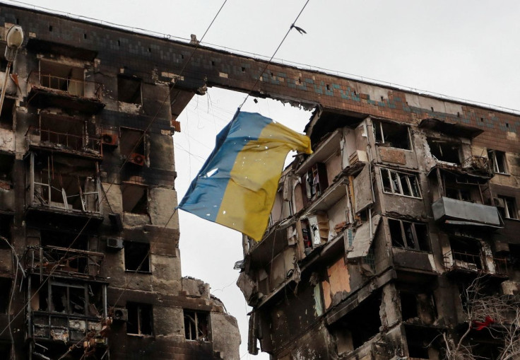 A view shows a torn flag of Ukraine hung on a wire in front an apartment building destroyed during Ukraine-Russia conflict in the southern port city of Mariupol, Ukraine April 14, 2022. 