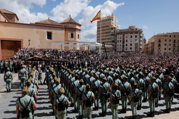 Spanish legionnaires carry a statue of the Christ of Mena outside a church, during a ceremony ahead of the Mena brotherhood procession, after processions were cancelled for the last two years due to the coronavirus disease (COVID-19) pandemic, in Malaga,