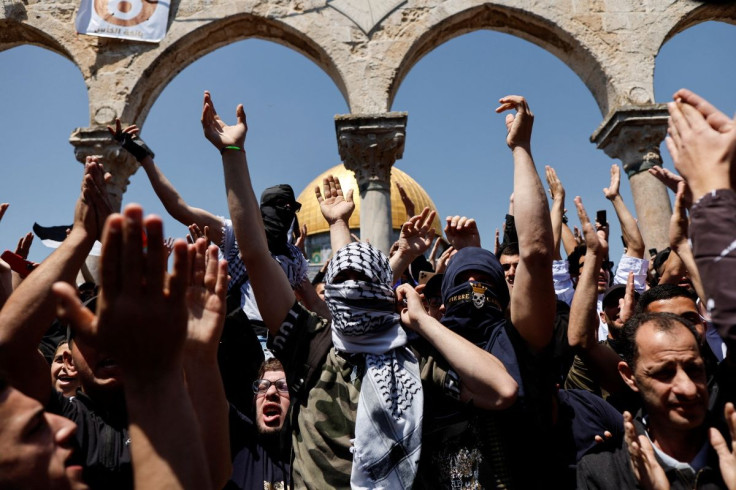 Palestinians shout slogans at the compound that houses Al-Aqsa Mosque, known to Muslims as Noble Sanctuary and to Jews as Temple Mount, following clashes with Israeli security forces in Jerusalem's Old City April 15, 2022.